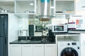 Fridge, stovetop, cookware/dishes/utensils - Stunning 2 Bedrooms Apartment at Ancol Mansion (Jakarta)
