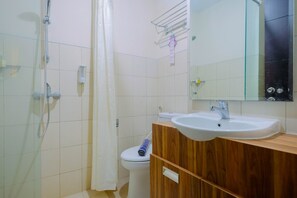 A bathroom with a shower, toilet, and sink. - Well Appointed 1BR Apartment at The Aspen Residences (Jakarta)
