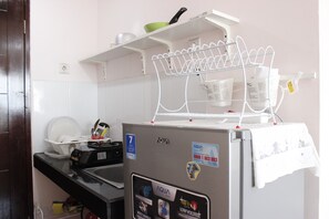 Fridge, stovetop, cookware/dishes/utensils - Cozy & Trendy Studio at Gateway Pasteur Apartment (Cimahi)