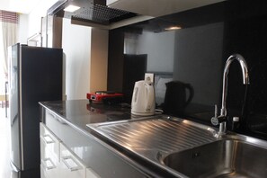 Room | Private kitchen | Fridge, stovetop, cookware/dishes/utensils - Strategic Studio at Green Kosambi Bandung Apartment (Bandung)