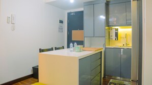 Room | Private kitchen | Fridge, stovetop, cookware/dishes/utensils - Cozy and Spacious 1BR Apartment at Casa De Parco (Pagedangan)
