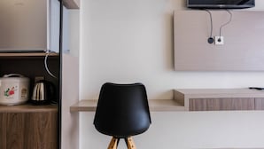A modern kitchen with a built-in microwave, a kettle, and a rice cooker on the countertop. - Highest Value Studio Room at Annora Living Apartment (Tangerang)