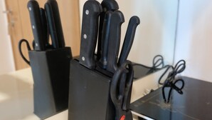 A kitchen counter with a knife block holding several knives. - Simply and Homey Studio Apartment at Tree Park City (Tangerang)