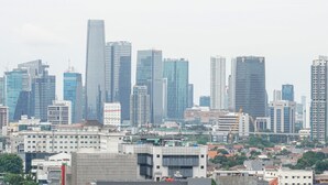 A cityscape with modern high-rise buildings, including a prominent skyscraper. - Cozy Studio Apartment at Nine Residence connected to Mall (Jakarta)