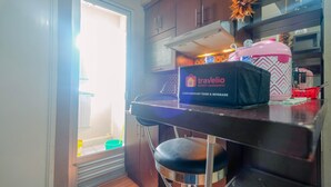 A compact kitchen with a countertop, a sink, and a window. - Strategic 2BR at Kalibata City Apartment (Jakarta)