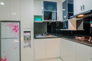 Fridge, stovetop, cookware/dishes/utensils - Well Designed 2BR Lexington Apartment (Jakarta)
