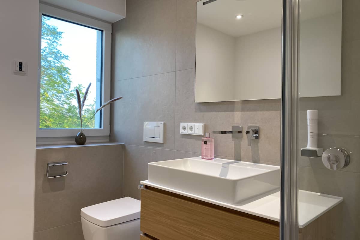 deluxe apartment | bathroom | shower, rainfall showerhead, hair dryer, heated floors