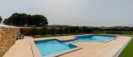 Seasonal outdoor pool, open 10:00 AM to 7:00 PM, pool loungers