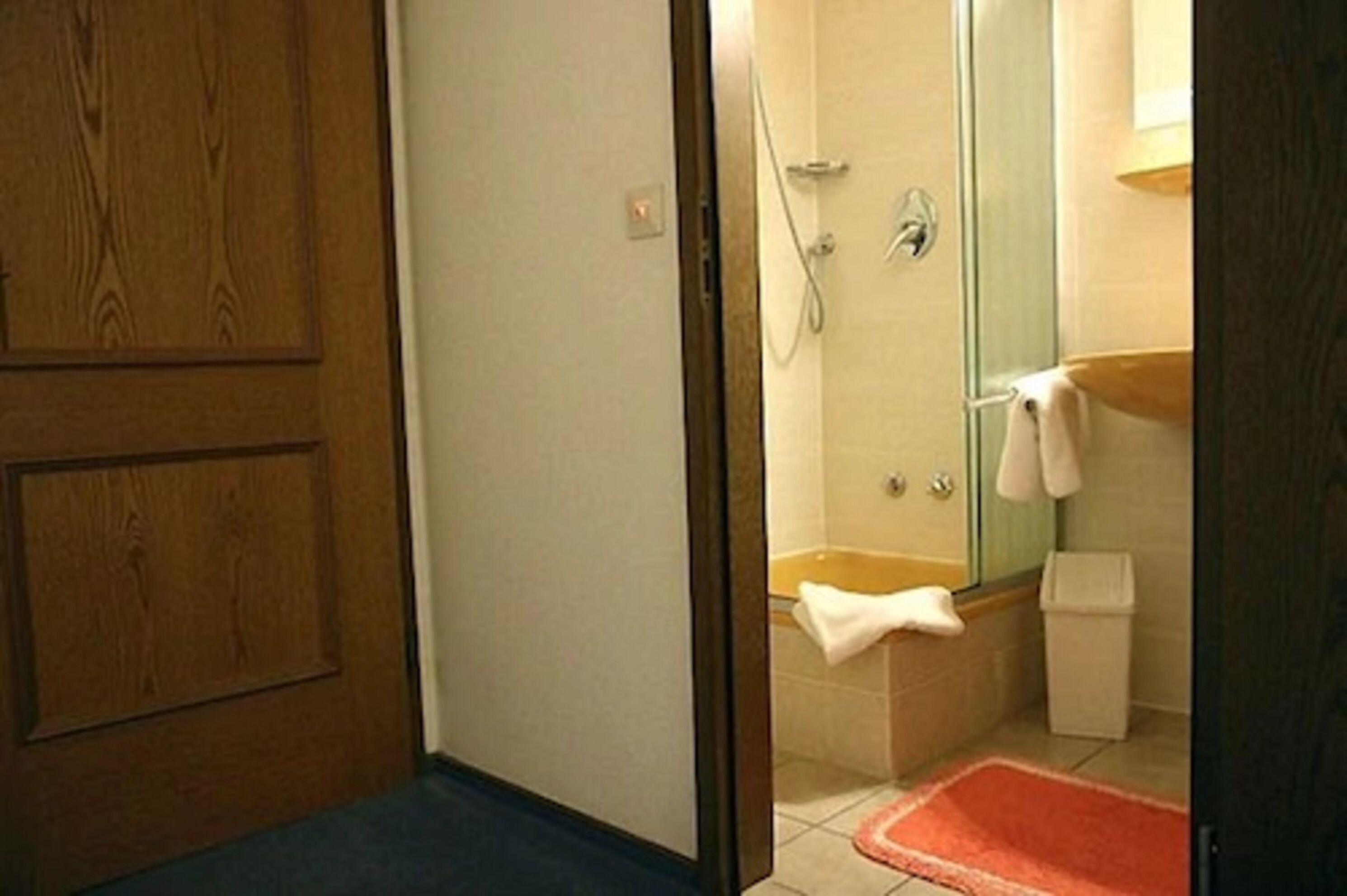 A bathroom with a shower, a bathtub, and a sink.