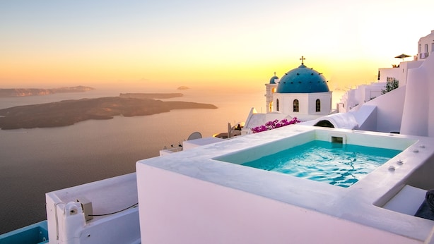 Un edificio blanco con una cúpula azul y una piscina.