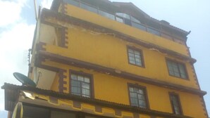 A multi-story building with a sign reading "GUEST" on the ground floor. - Kikuyu Guest House (Kikuyu)
