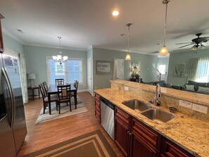 Enjoy cooking in this well-equipped kitchen with a dishwasher and double sink.