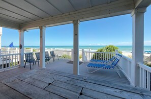 A wooden deck with chairs and a view of the beach. - Portofino IV 2002 - Oceanfront in Garden City Beach (Garden City)