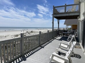 A wooden deck with white chairs overlooking a beach. - Vitamin Sea - Oceanfront in Surfside Beach (Surfside Beach)