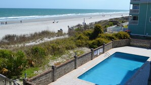A pool area with a view of the beach and ocean. - Surfwatch II 202 - Oceanfront in Surfside Beach (Surfside Beach)