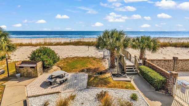 A beachside property with a patio, a wooden deck, and a view of the ocean. - Surfwatch II 202 - Oceanfront in Surfside Beach (Surfside Beach)