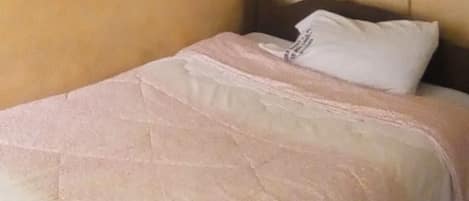 A room with a bed, a white canopy, and a checkered floor.