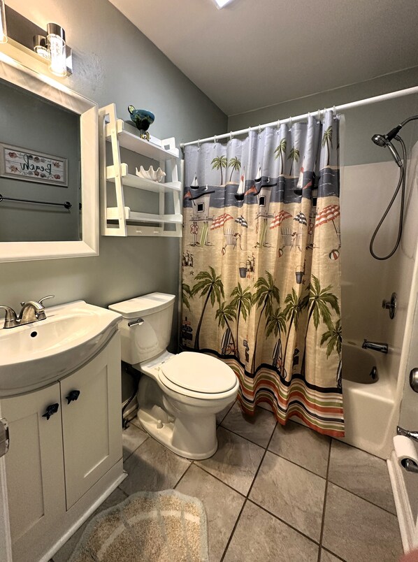 A bathroom with a toilet, sink, and bathtub. - Sea Shadow 306 - Oceanfront in Surfside Beach (Surfside Beach)