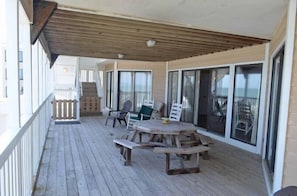 Enjoy al fresco dining on the deck with a wooden table and comfortable seating.