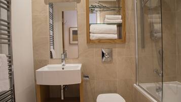 Combined shower/bathtub, towels, soap, toilet paper