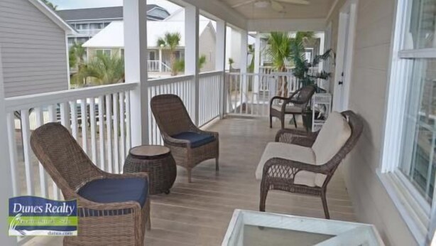 A covered porch with wicker furniture, a ceiling fan, and a view of the neighborhood. - Summer Winds 14 - Second Row Complex in Garden City Beach (Garden City)