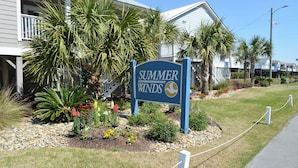 A sign for 'Summer Winds' with a view of a building and palm trees. - Summer Winds 14 - Second Row Complex in Garden City Beach (Garden City)
