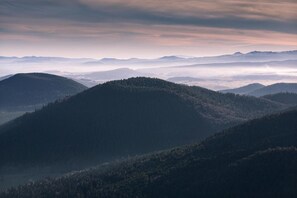 A mountainous landscape with dense forests and a misty atmosphere. - La Rosière 2. A heavenly place in the midst of nature, peace and quiet. (Auzelles)