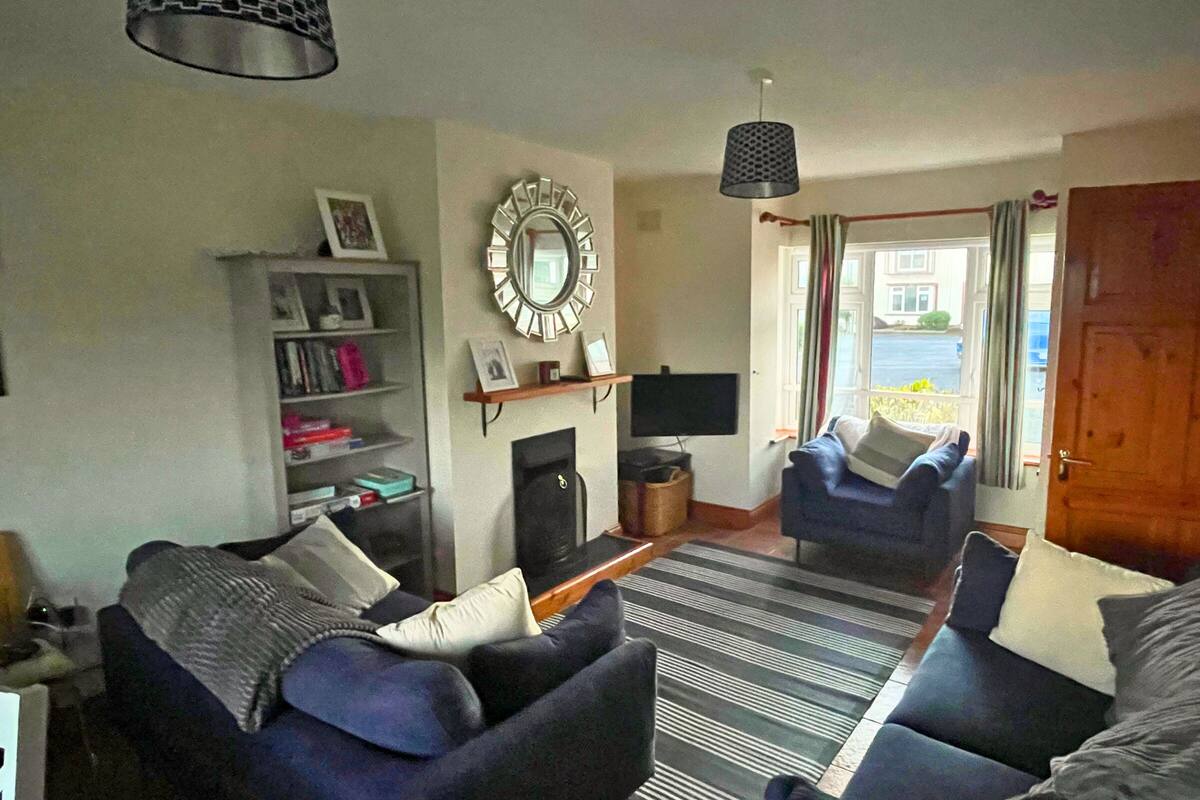 A living room with a fireplace, a TV, and a bookshelf.