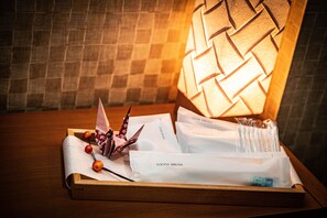 A wooden tray with a tissue box, a hairbrush, a toothbrush, and a tube of toothpaste. - Kaguya Asakusa - Hostel, Caters to Women (Tokyo)