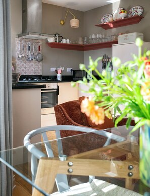 A modern kitchen with a Bosch oven, a microwave, and a bread maker on the counter.