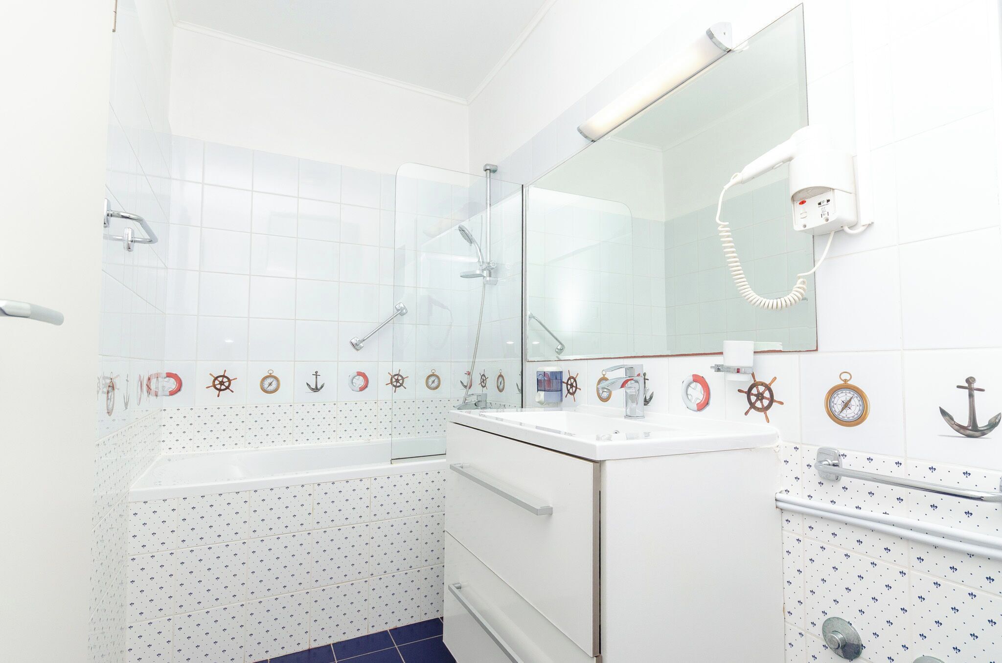 A bathroom with a bathtub, a shower, a toilet, and a sink.