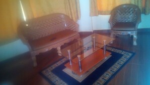 A living room with a sofa, a coffee table, and a patterned rug.