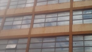A multi-story building with a grid of windows and a sign above reading "The Radisson."