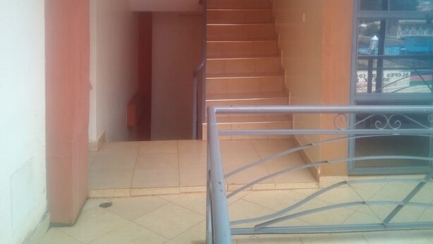A staircase with metal railings leading to an upper floor.