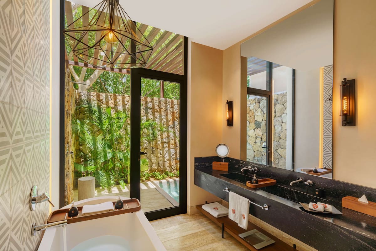 itza plunge pool suite - king | bathroom | shower, rainfall showerhead, hair dryer, bathrobes