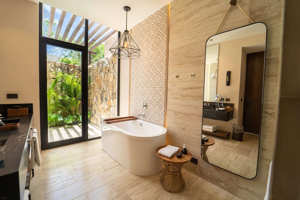 itza plunge pool suite - king | bathroom | shower, rainfall showerhead, hair dryer, bathrobes