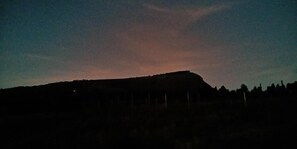A silhouette of a hill with a flat top, surrounded by a forested area. - Zama Hotel (Nakuru)