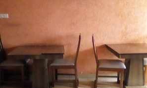 Simple, functional room with a central table and two chairs.