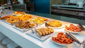 A buffet with various food items including croissants, pastries, and hot dogs. - Silver Beach Hotel (Kos)