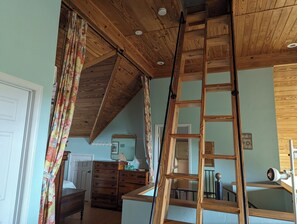 A room with a wooden ceiling, a wooden ladder, a dresser, and a mirror. - The Sandy Seagull Hideaway, pristine Cayo Costa Island, SW Florida! (Cayo Costa)