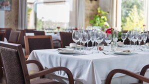 A restaurant with a long table set for dining, chairs, and a view through large windows. - Rural Idyll Villa "Sa Pleta" with Pool (Petra)