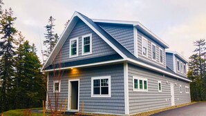 A two-story house with a grey siding exterior, white trim, and a sloped roof. - The Overlook at Orchard Hills -- Hilltop Retreat,  Near Acadia (Tremont)