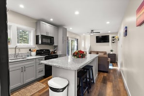 Enjoy cooking in this well-equipped kitchen with a large island and ample storage.
