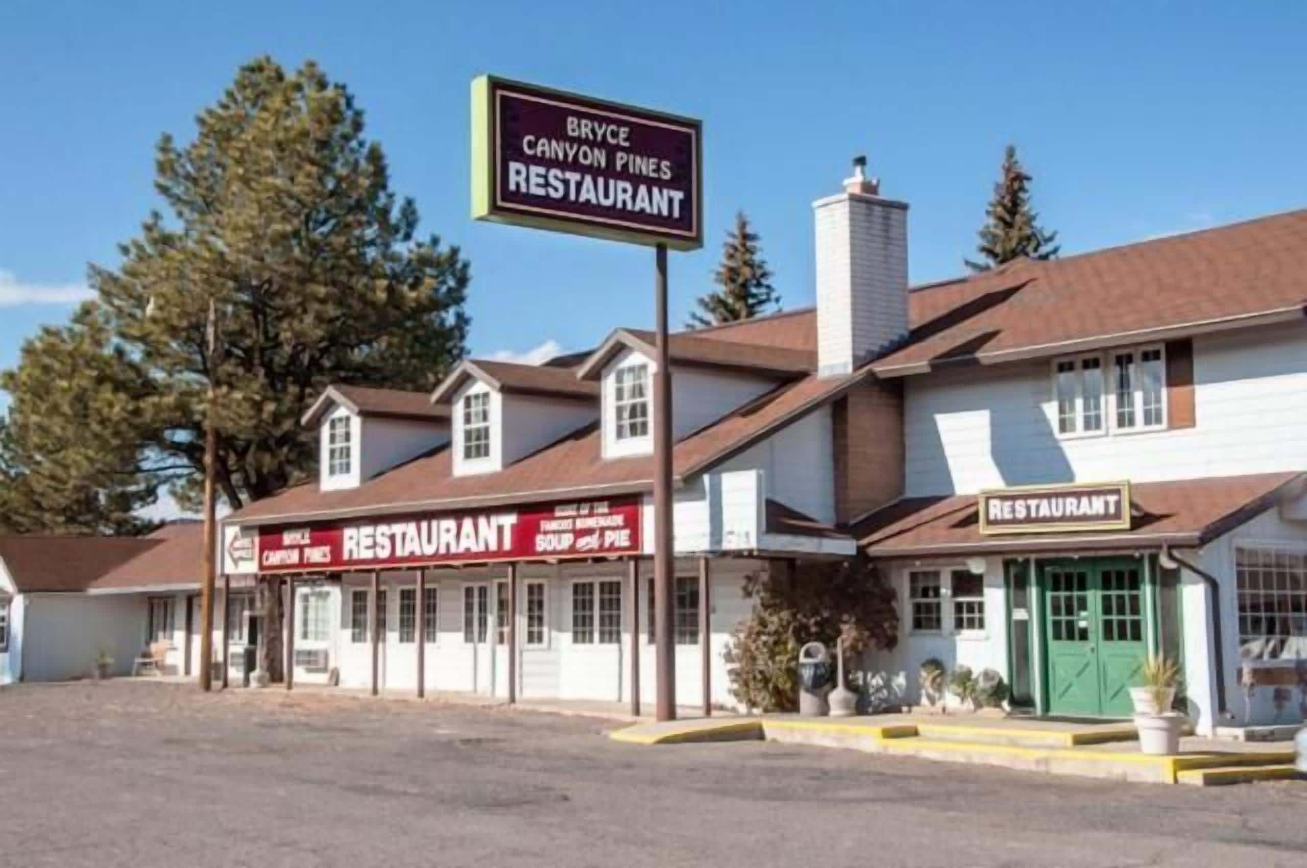 A building with multiple signs indicating it is a restaurant named Bryce Canyon Pines.