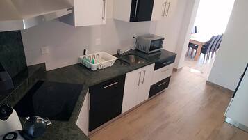 Family Apartment, 3 Bedrooms | Private kitchen | Full-sized fridge, microwave, oven, stovetop