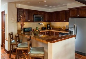 Enjoy cooking in this well-equipped kitchen with an oven, microwave, and refrigerator.