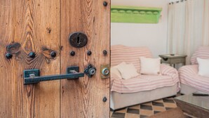 En trædør med lås, en stribet sofa og et lille bord i et rum.