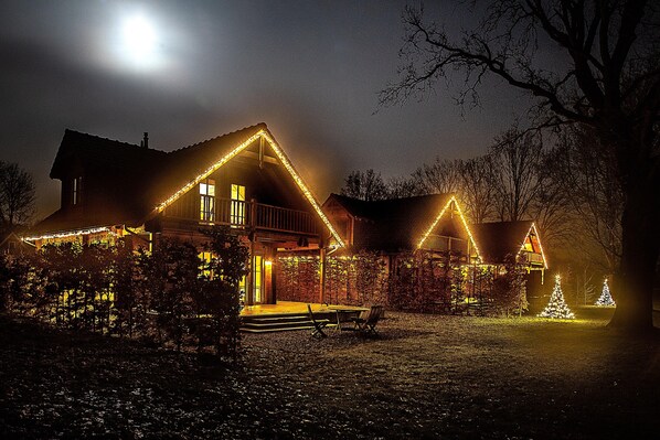 A house with a porch, a bench, and Christmas lights.