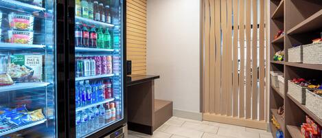 A self-service beverage station with refrigerated drink options and snacks.