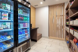 A self-service beverage station with refrigerated drink options and snacks. - Holiday Inn Express Durango Downtown-Animas River by IHG (Durango)